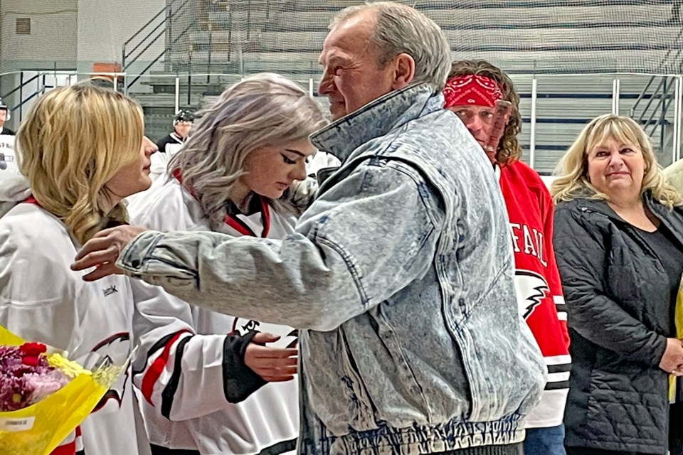 Former Eagles' coach Brian Sutter warmly greets the three children of the late Tyler Haarstad after they were presented with Eagles jerseys with their dad's name and number of the back and the last hockey stick he used while he was still an Innisfail Eagle. Johnnie Bachusky/MVP Staff