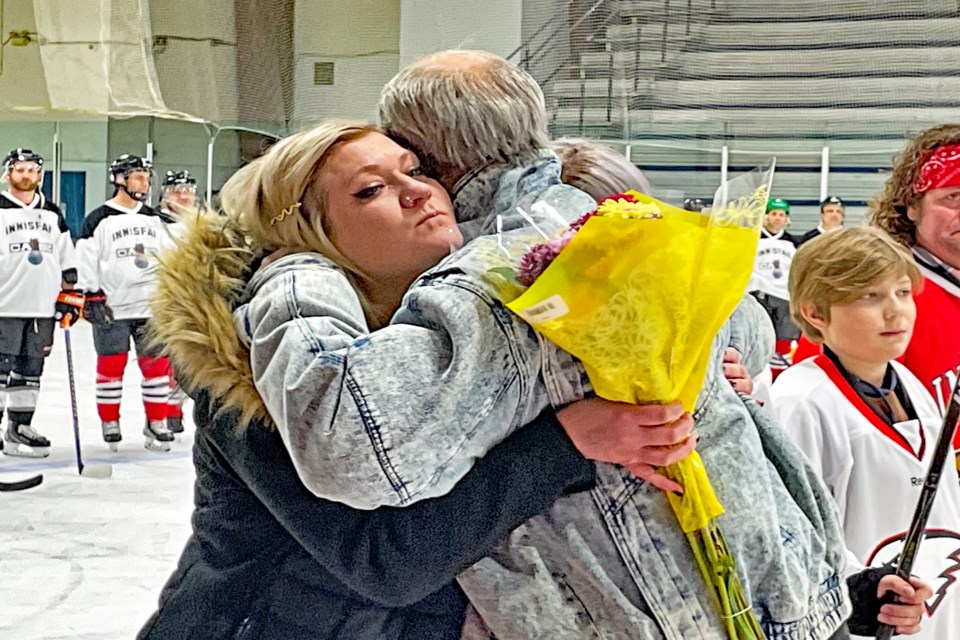 Bailey Quirico, the mother of the late Tyler Haarstad's three children, receives a heartfelt hug from former Eagles coach Brian Sutter on Feb. 25 at the Innisfail Arena during a tribute for the former Innisfail Eagles hockey player who passed away on June 9, 2022. Johnnie Bachusky/MVP Staff